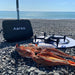 Aeroo Pro Drone on landing pad with fish caught and carry case with ocean in background