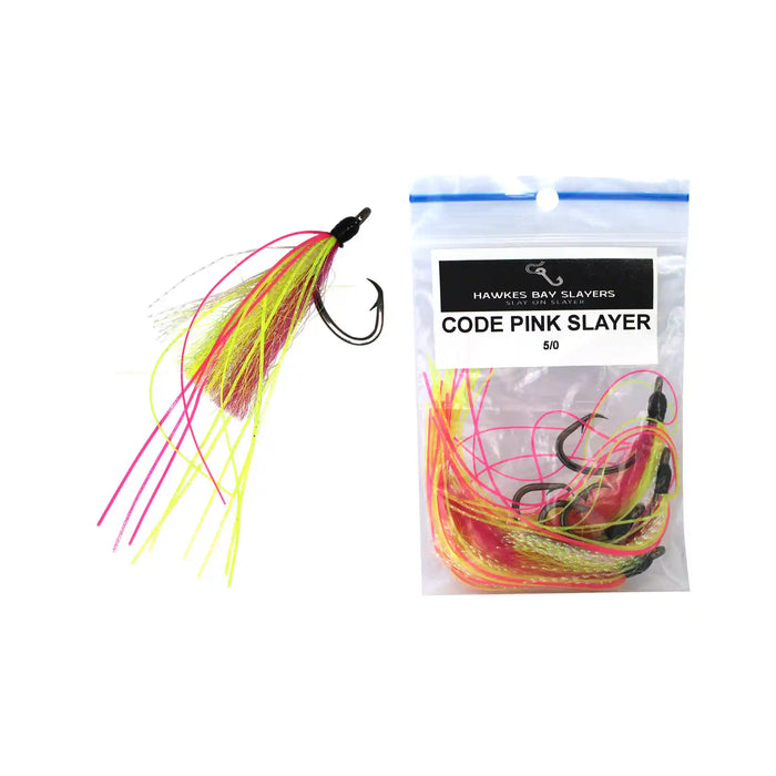 A fishing lure shown beside its retail bag. The lure has a black hook with a skirt made of bright pink, neon yellow, and tan strands.